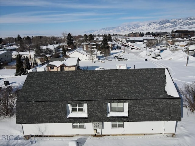 snowy aerial view featuring a mountain view