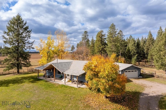 exterior space with a front yard and a rural view