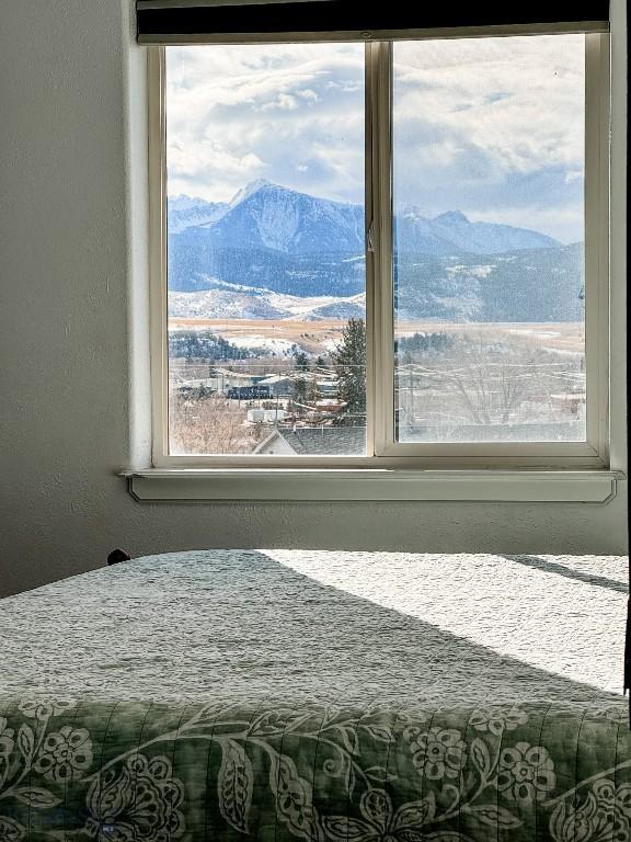 bedroom featuring a mountain view