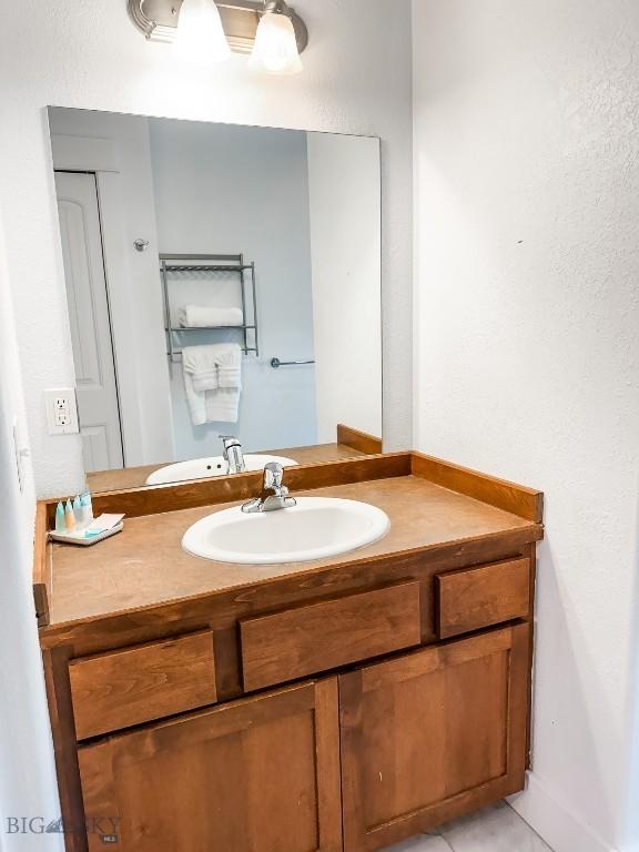 bathroom featuring tile patterned floors and vanity