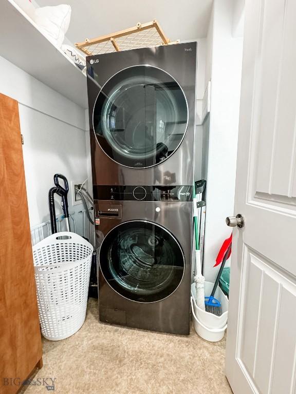 laundry room with stacked washer / drying machine