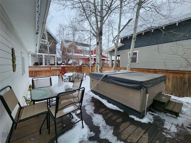 snow covered deck featuring a hot tub