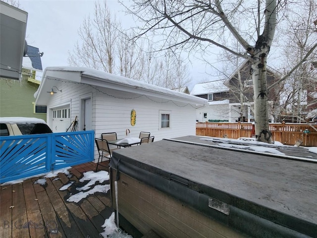 snow covered deck featuring a hot tub