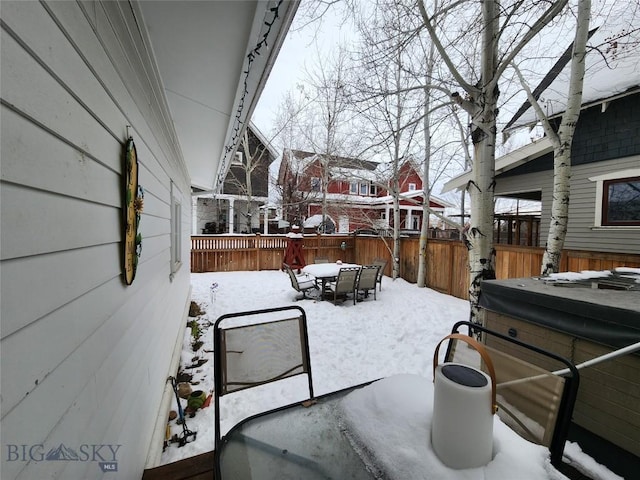 snow covered patio with a hot tub