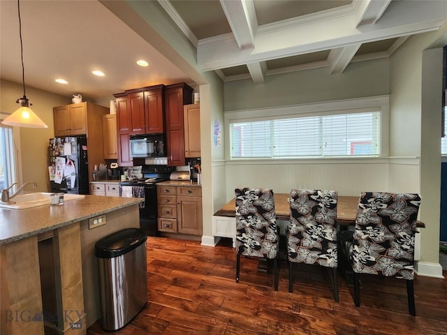 kitchen featuring sink, dark wood-type flooring, beam ceiling, black appliances, and decorative light fixtures