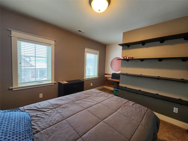 bedroom featuring multiple windows and carpet