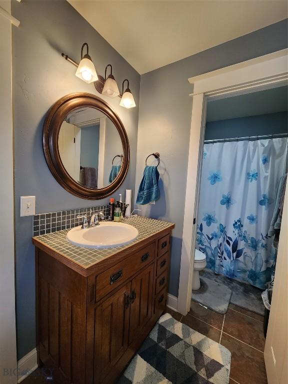 bathroom featuring vanity, toilet, and tile patterned flooring