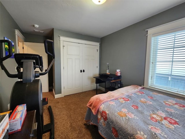 carpeted bedroom featuring a closet