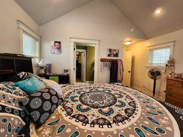 bedroom featuring high vaulted ceiling and multiple windows