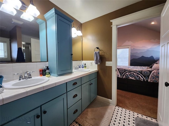 bathroom with tile patterned floors, vanity, and backsplash