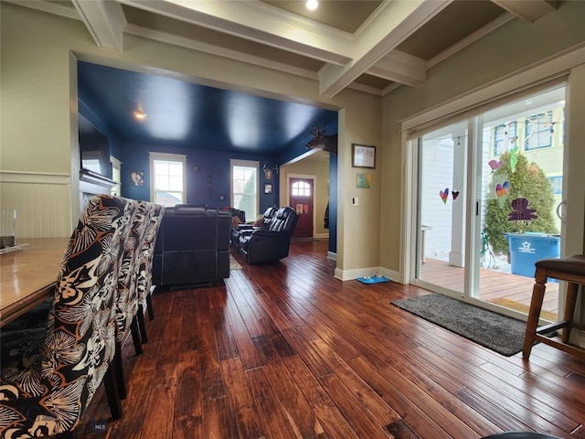 unfurnished living room with beam ceiling, wood-type flooring, and plenty of natural light