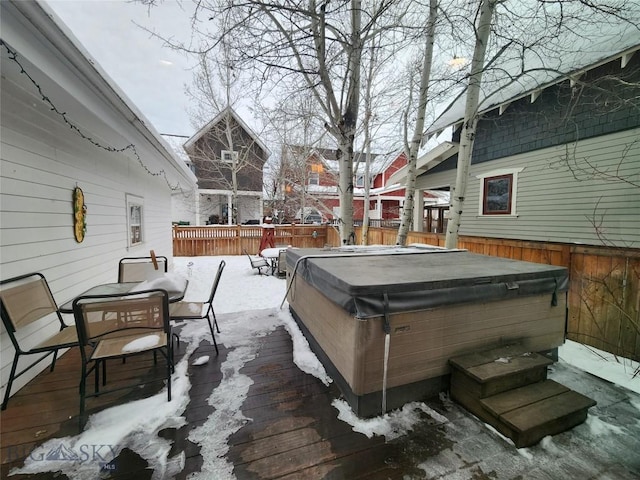 snow covered deck featuring a hot tub