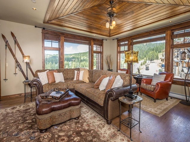 living room with wood ceiling, baseboard heating, a raised ceiling, and hardwood / wood-style floors