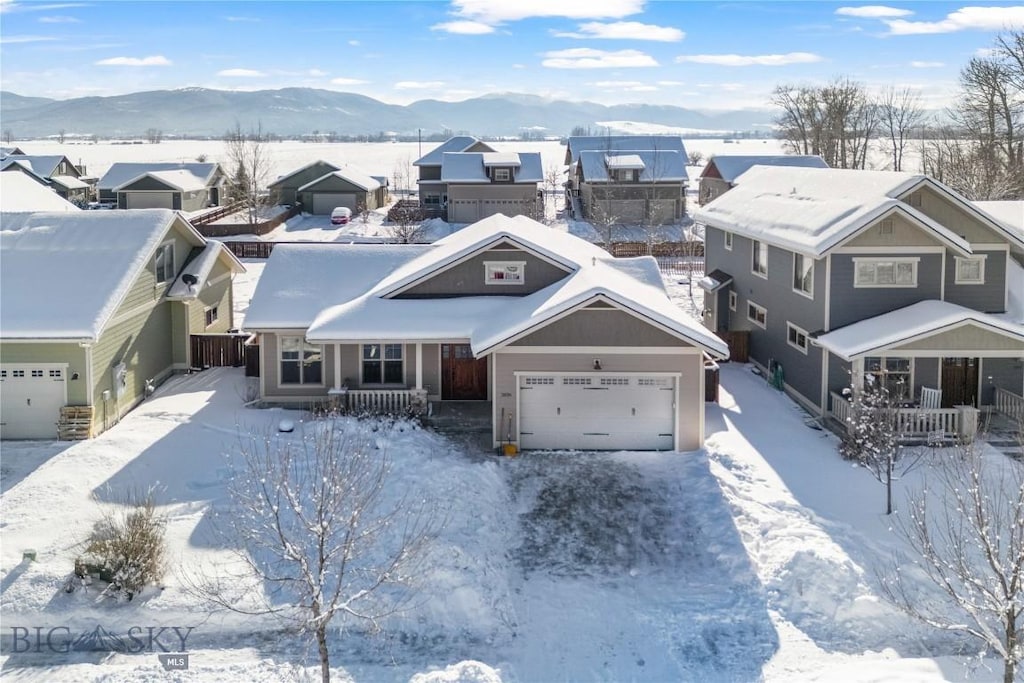 snowy aerial view featuring a mountain view