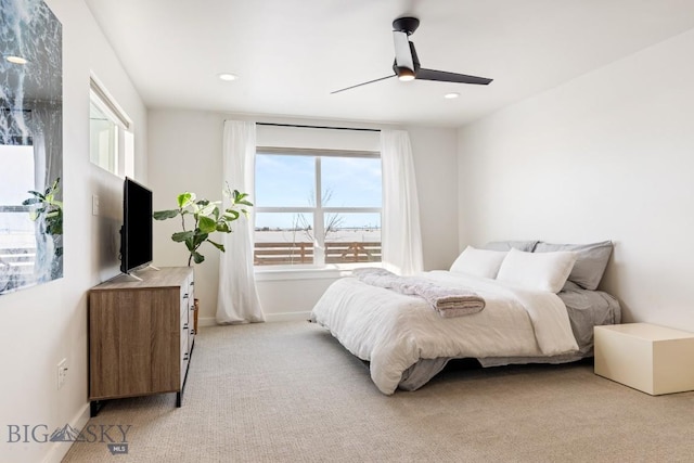 bedroom featuring light colored carpet and ceiling fan