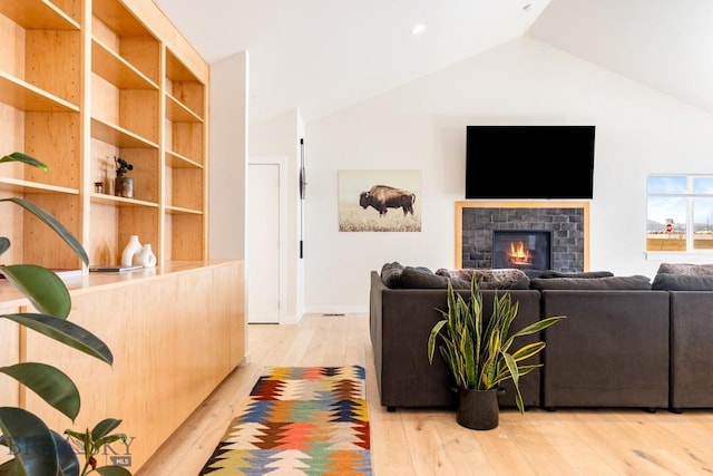 living room with lofted ceiling and light hardwood / wood-style flooring