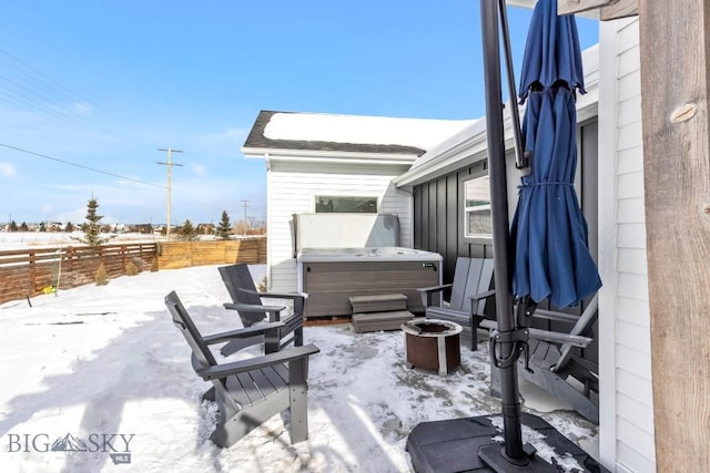 snow covered patio with a hot tub