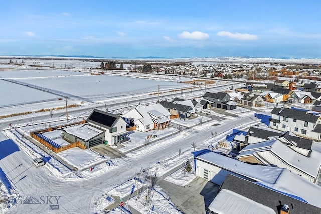 snowy aerial view featuring a residential view