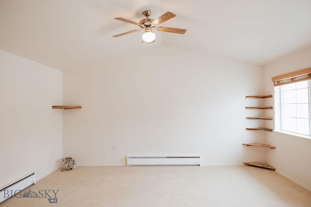 empty room featuring vaulted ceiling, a baseboard heating unit, light colored carpet, and ceiling fan