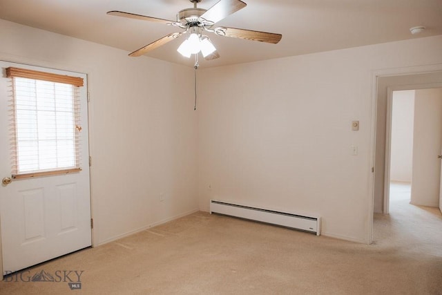 carpeted spare room with baseboard heating and ceiling fan