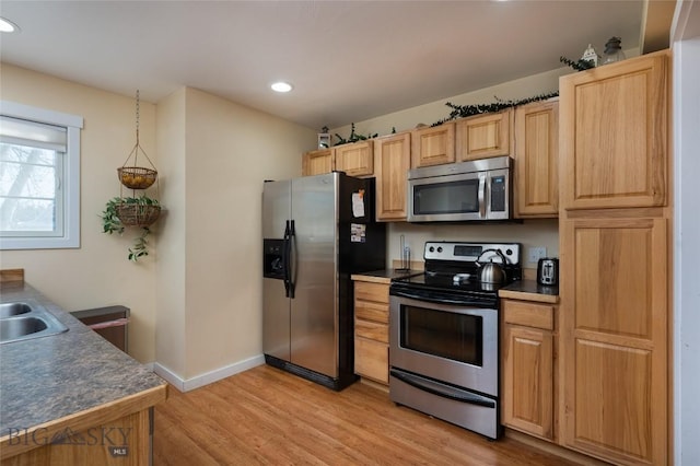 20 Talon Way Unit D, Bozeman, MT 59718 - kitchen featuring appliances with stainless steel finishes, light wood-type flooring, recessed lighting, baseboards, and dark countertops