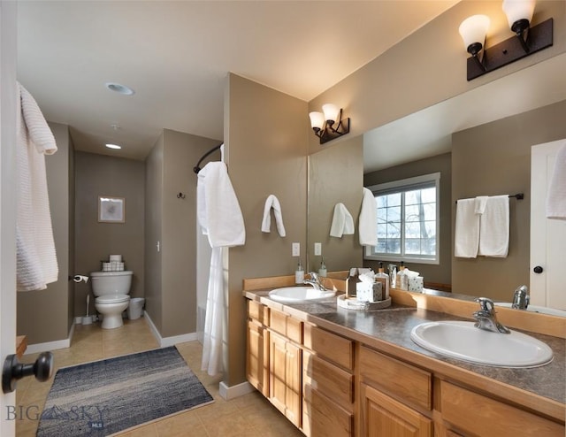 20 Talon Way Unit D, Bozeman, MT 59718 - bathroom featuring tile patterned floors, toilet, double vanity, and baseboards