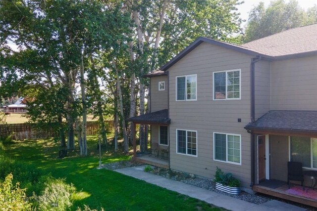 20 Talon Way Unit D, Bozeman, MT 59718 - back of property featuring a shingled roof and a patio area