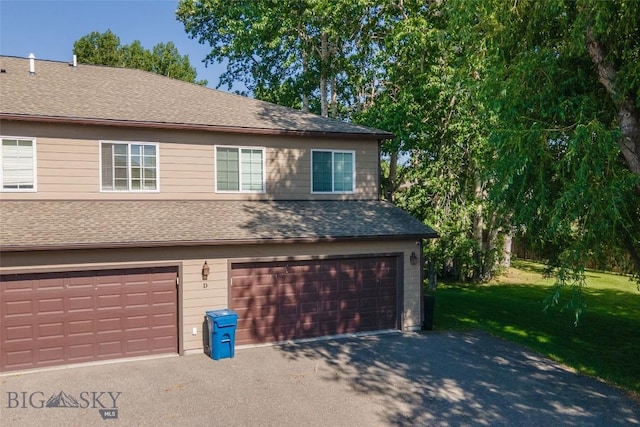 20 Talon Way Unit D, Bozeman, MT 59718 - view of front of home featuring a front yard, a garage, a shingled roof, and driveway