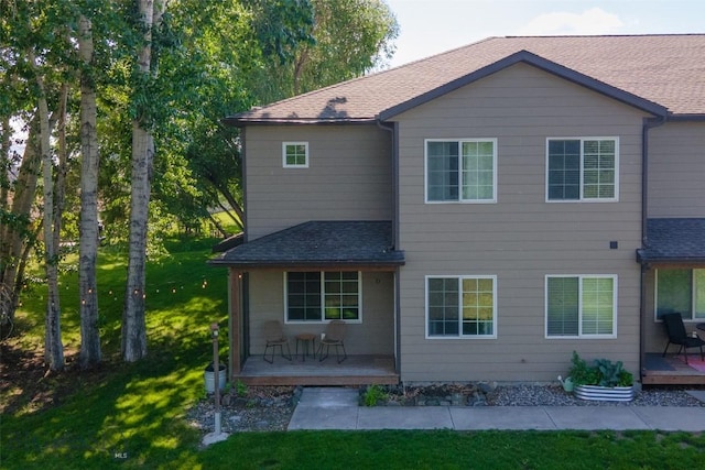 20 Talon Way Unit D, Bozeman, MT 59718 - back of property featuring roof with shingles, a lawn, and a wooden deck