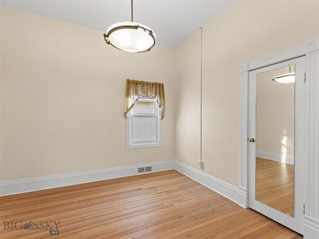 empty room with light hardwood / wood-style flooring