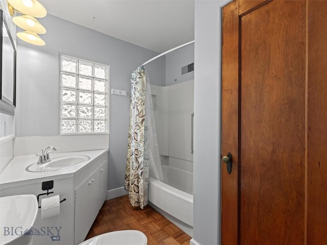 bathroom featuring vanity, parquet flooring, and shower / bath combo