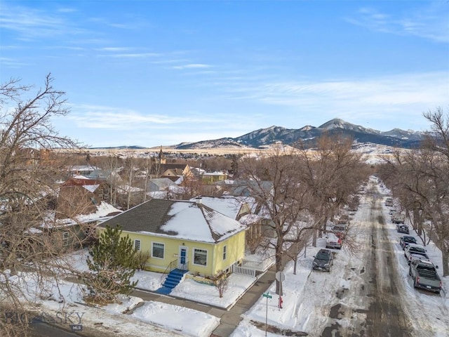 snowy aerial view featuring a mountain view