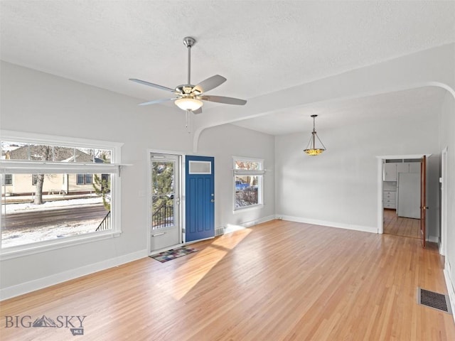 entryway featuring ceiling fan, a textured ceiling, and light wood-type flooring