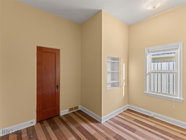 spare room with light hardwood / wood-style floors