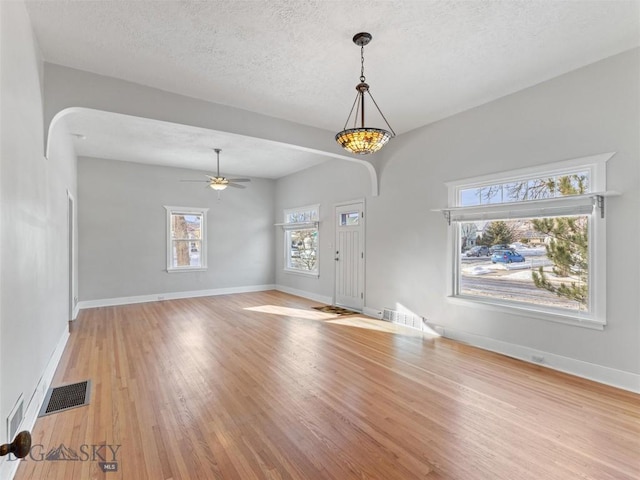 foyer featuring ceiling fan, a textured ceiling, and light hardwood / wood-style floors