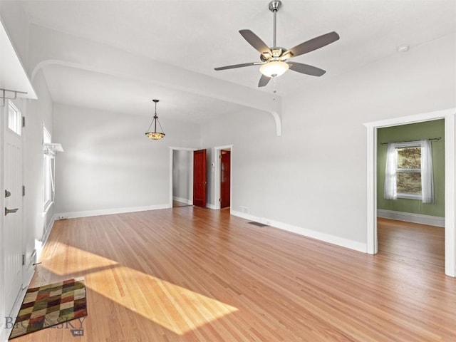 unfurnished living room with wood-type flooring and ceiling fan