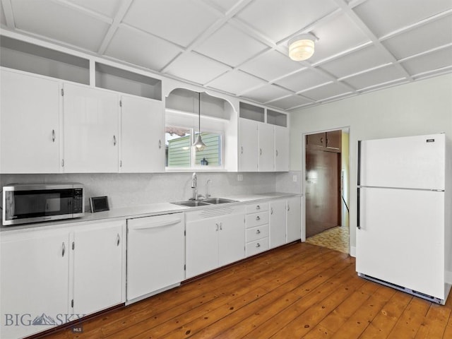 kitchen with pendant lighting, white cabinetry, wood-type flooring, sink, and white appliances