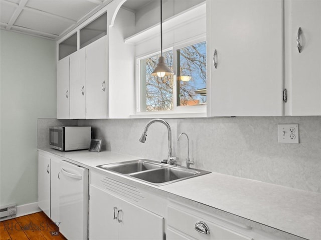 kitchen with sink, dishwasher, decorative backsplash, white cabinets, and decorative light fixtures