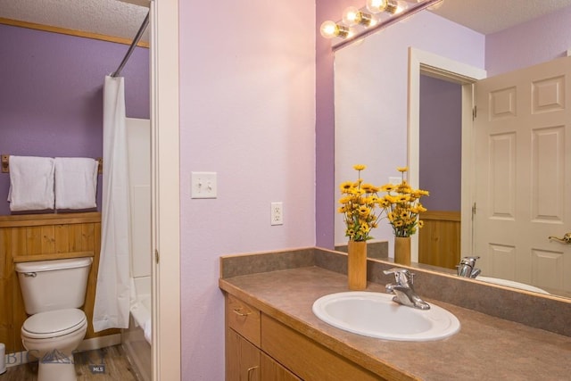 full bathroom featuring shower / bath combo, wood-type flooring, vanity, and toilet