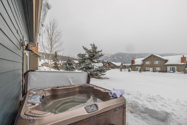 yard layered in snow with a covered hot tub