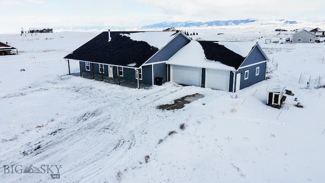 snowy aerial view with a mountain view