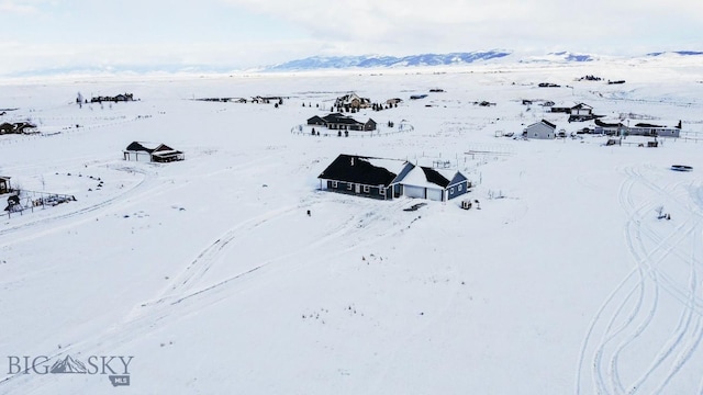 snowy aerial view with a mountain view