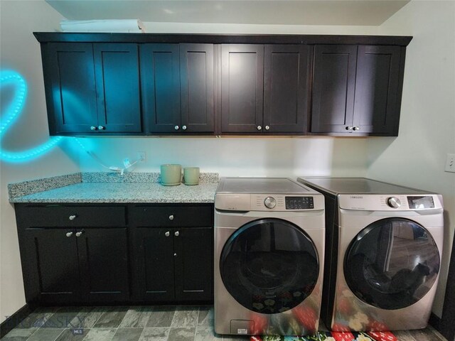 laundry room featuring cabinet space and separate washer and dryer