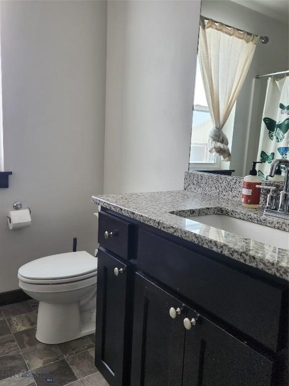 full bath featuring toilet and vanity