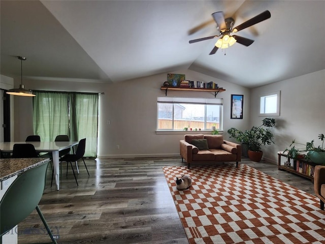 living room featuring lofted ceiling, dark wood-type flooring, and ceiling fan