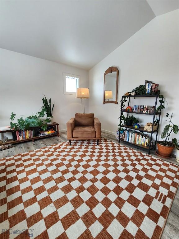 living area featuring lofted ceiling