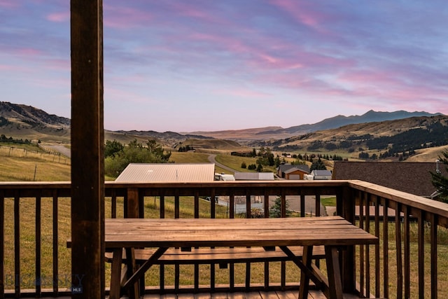 deck at dusk featuring a mountain view