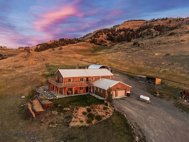 aerial view at dusk featuring a mountain view