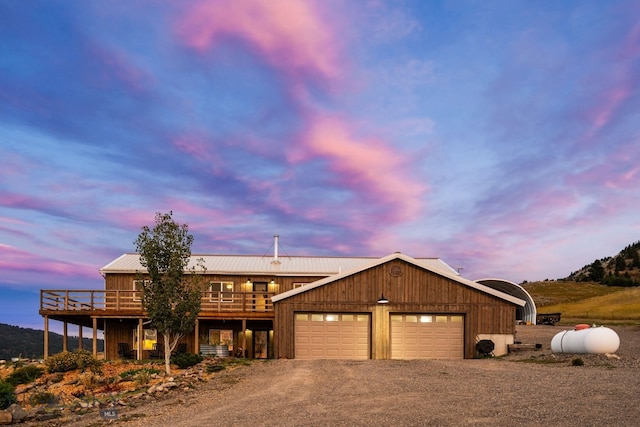 view of front of house with a wooden deck and a garage