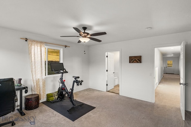 workout area featuring ceiling fan and light colored carpet